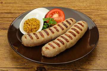 Grilled natural pork sausages with sauce