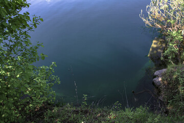 Beautiful river in the highlands in summer. Lake in an ecologically clean park reserve on a background of hills. A pretty landscape in the spring. Stock photo for design