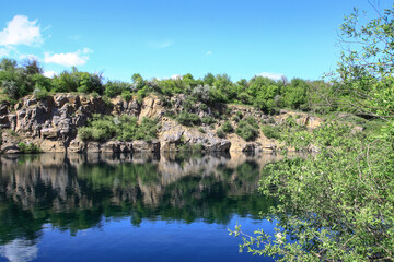Beautiful river in the highlands in summer. Lake in an ecologically clean park reserve on a background of hills. A pretty landscape in the spring. Stock photo for design
