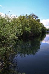 Beautiful river in the highlands in summer. Lake in an ecologically clean park reserve on a background of hills. A pretty landscape in the spring. Stock photo for design