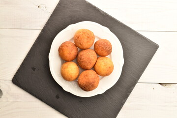 Fresh aromatic, cheese donuts, close-up, on a slate board.