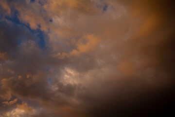 Picturesque evening sky over the city after a thunderstorm. Colorful thunderclouds in the sunset light.