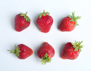 Tasty ripe strawberries on white background, flat lay
