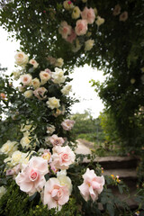 Floral wedding arch from roses on sky background