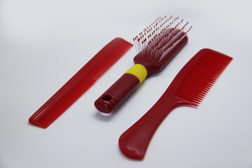 Fototapeta premium Red hair brush and combs, determined to comb and brush hair