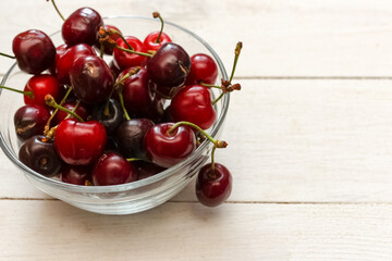 Sweet cherry lies in a bowl on the table. Cherry is a tasty and healthy berry.