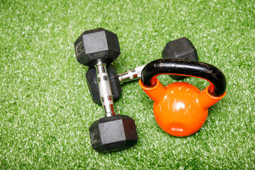 Gym equipment on grass background. Concept preparing to fitness sports equipment top view.