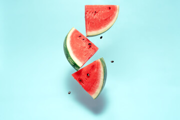 Watermelon slice falling on pastel background. Floating fruits in the air. Flying red fruits....