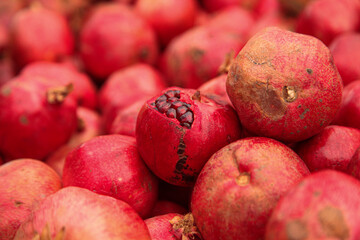 Whole and peeled red pomegranates