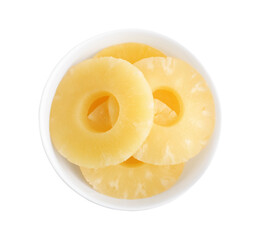 Delicious canned pineapple rings in bowl on white background, top view