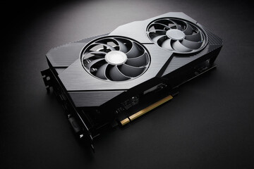 modern black computer video card on a black background, deep shadows and contrasting light, one...