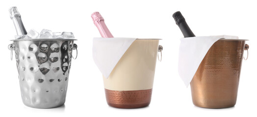 Buckets with bottles of champagne and ice on white background