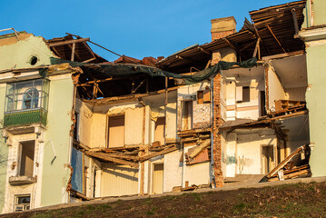 The wall of a destroyed multi-storey residential building.