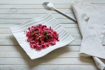 healthy diet beetroot salad in white bowl on grey background