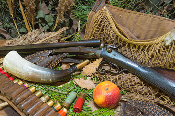 Beautiful hunting still life. Vintage hunting gun, horn, bag, belt with cartridges