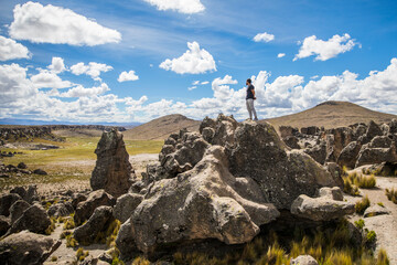 Fototapeta premium young man standing on a rock in the stone forest