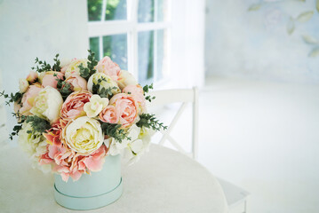 wedding bouquet stand near the window on the table