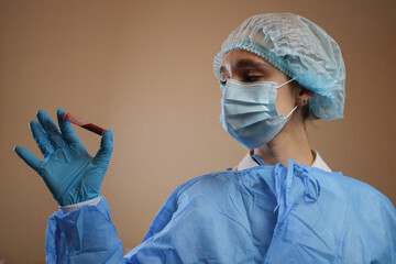 A doctor holds a test tube with a coronavirus positive blood sample. stop coronavirus. MERS....