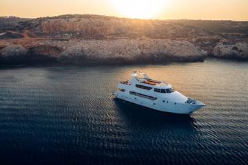 Fototapeta na wymiar Cruise yacht at Blue lagoon near Cape Greco Peninsula. Cyprus