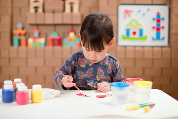 toddler girl practice color painting  at home