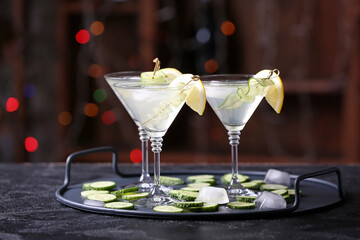 Glasses of tasty cucumber martini on table in bar