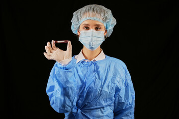 A doctor / nurse holds a test tube with a coronavirus positive blood sample. 2020 pandemic. stop...