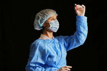 A doctor / nurse holds a test tube with a coronavirus positive blood sample. 2020 pandemic. stop...