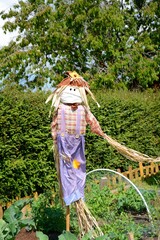 Keep 2 metres to the left please!   Masked scarecrow seeming to direct people during pandemic.