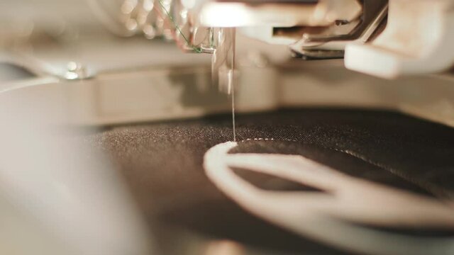 The automatic embroidery machine is working at high speed. Close-up