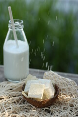 Bottle of milk and coconut marmalade. They pour it on top.
