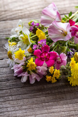 Wild flowers bouquet on wooden background