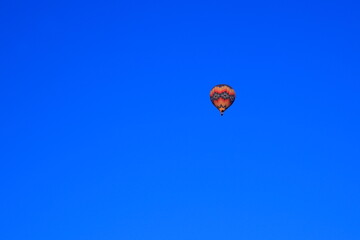 View of a hot balloon in the blue sky.