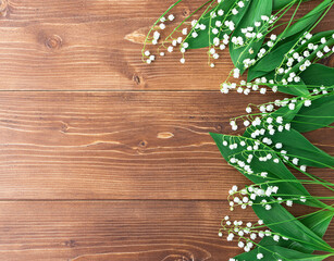 White lilies of the valley on a wooden background. copyspace
