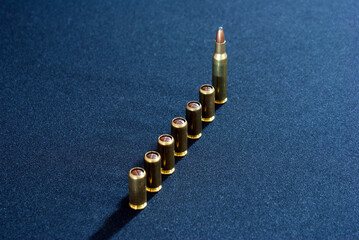 Obraz na płótnie Canvas Row of weapon cartridges on a dark background