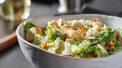 fresh caesar salad with croutons and parmasan cheese in bowl - obrazy, fototapety, plakaty