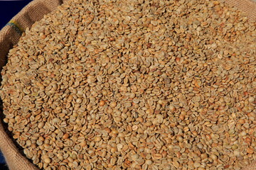 Green unroasted coffee beans. Stack view.