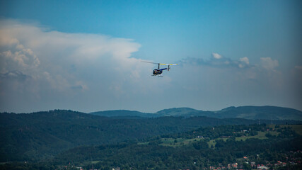 Robinson 44 Raven II helicopter at flight over Karkonosze mountains in Poland