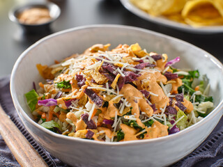 crunchy mexican salad with multi color tortilla strips and chipotle ranch dressing