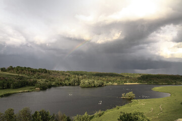 Nice big mountain river with a beautiful view. A rock on the side of a brook. Stock landscape for design