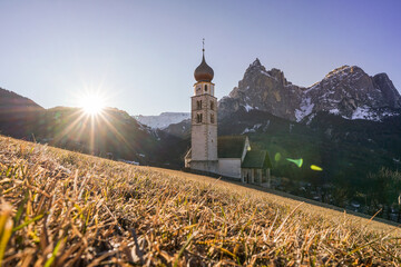 Panoramic view of a mountain scenery in the Dolomites with St. Valentin Church and famous Mount...