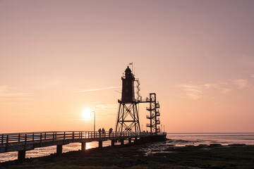 Fototapeta na wymiar sunset over the Lighthouse Obereversand - Wurster Nordseeküste