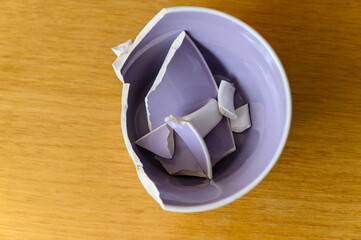 Broken ceramic mug with purple inside.