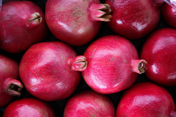 Fresh pink pomegranates in the grocery shop