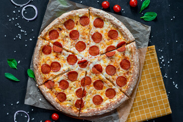 Pizza pepperoni with mozzarella on a black background