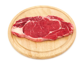 Fototapeta premium Raw steak on wooden plate isolated on white background