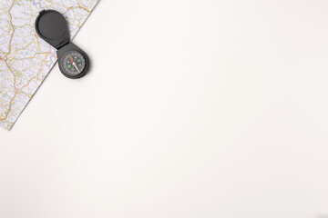 Traveler accessories. Map with compas on white background with empty space for text. Travel vacation concept. Summer background. Flat lay, top view. © Konstantin Maslak