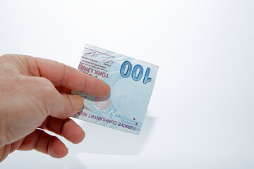 Composition of 100 Turkish Lira banknotes on white background and Keeping.
