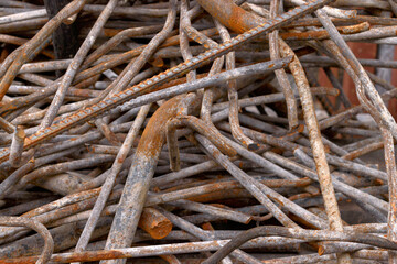 Stack of rusty iron rods or bars. Old metal rusty or steel rod.