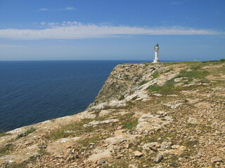 Seascape with the white lighthouse in Cap de Barbaria, Formentera island, Spain