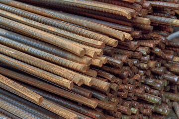 Stack of rusty iron rods or bars. Old metal rusty or steel rod.